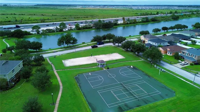 an aerial view of a golf course with a lake view