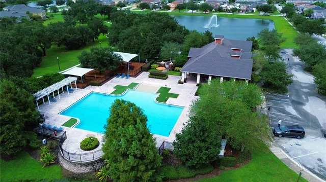 an aerial view of a house with outdoor space and lake view