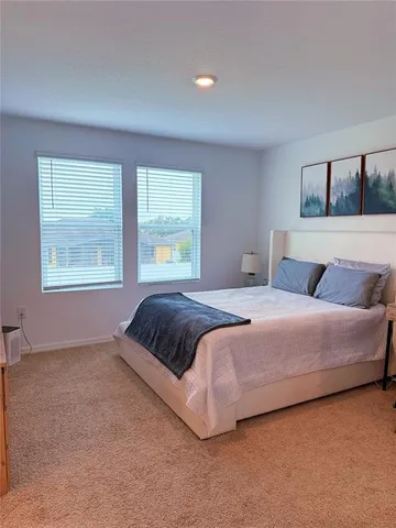 a bedroom with a large bed and a window