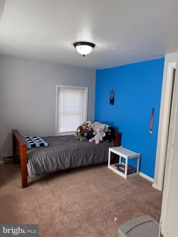 a bed room with a bed and a window