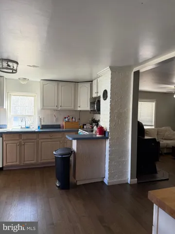 a kitchen with wooden floors and wooden cabinets