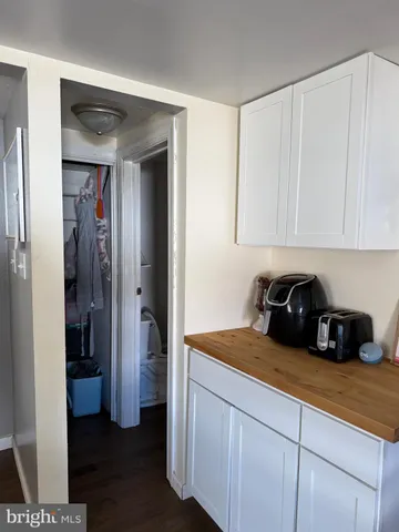 a kitchen with a refrigerator and cabinets