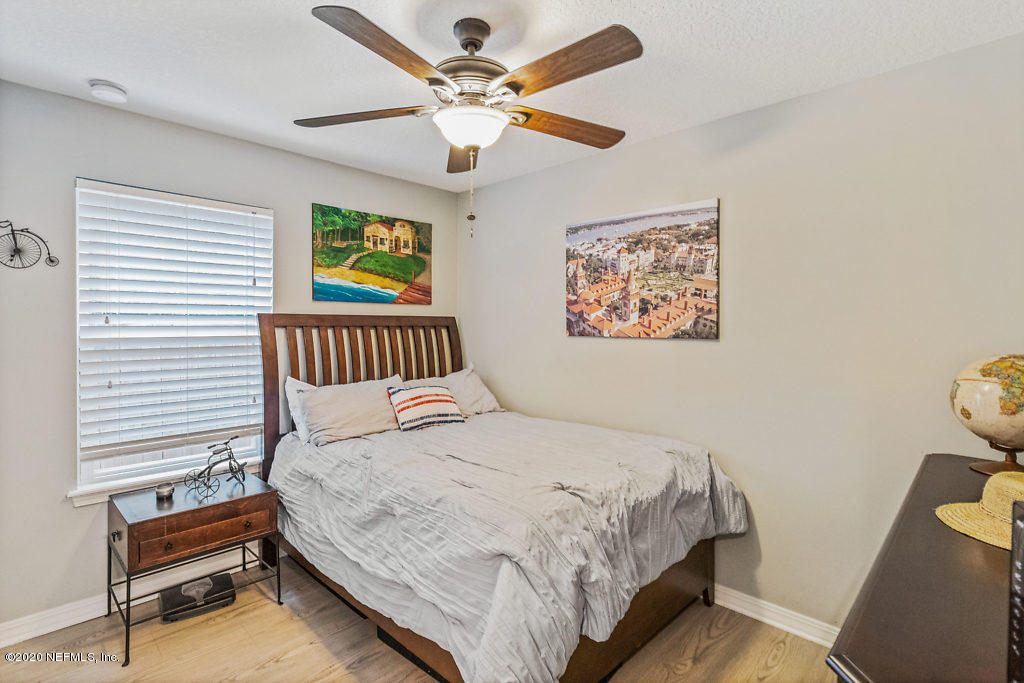 405 2nd Street St. Augustine, FL 32084 - Photo 13 of 49 a bedroom with a bed and a chandelier