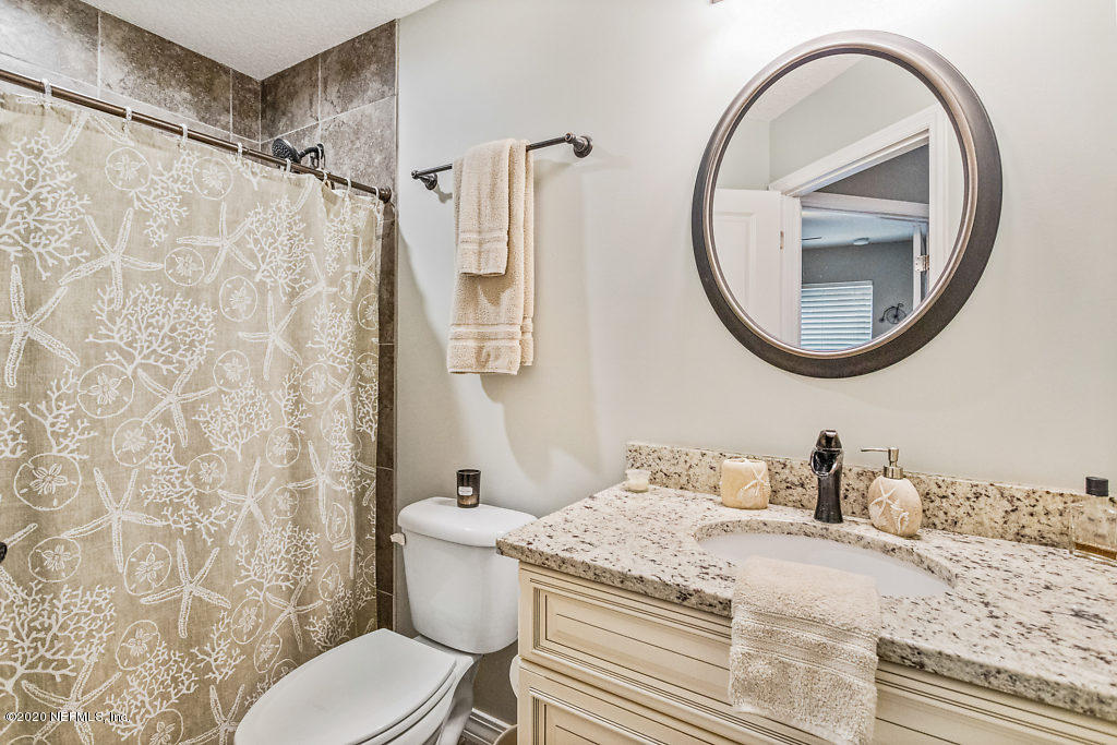 405 2nd Street St. Augustine, FL 32084 - Photo 16 of 49 a bathroom with a granite countertop sink and a mirror