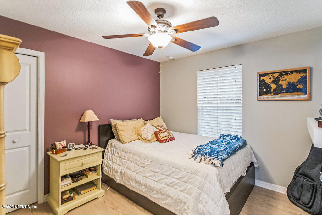 405 2nd Street St. Augustine, FL 32084 - Photo 17 of 49 a bedroom with a bed and a chandelier