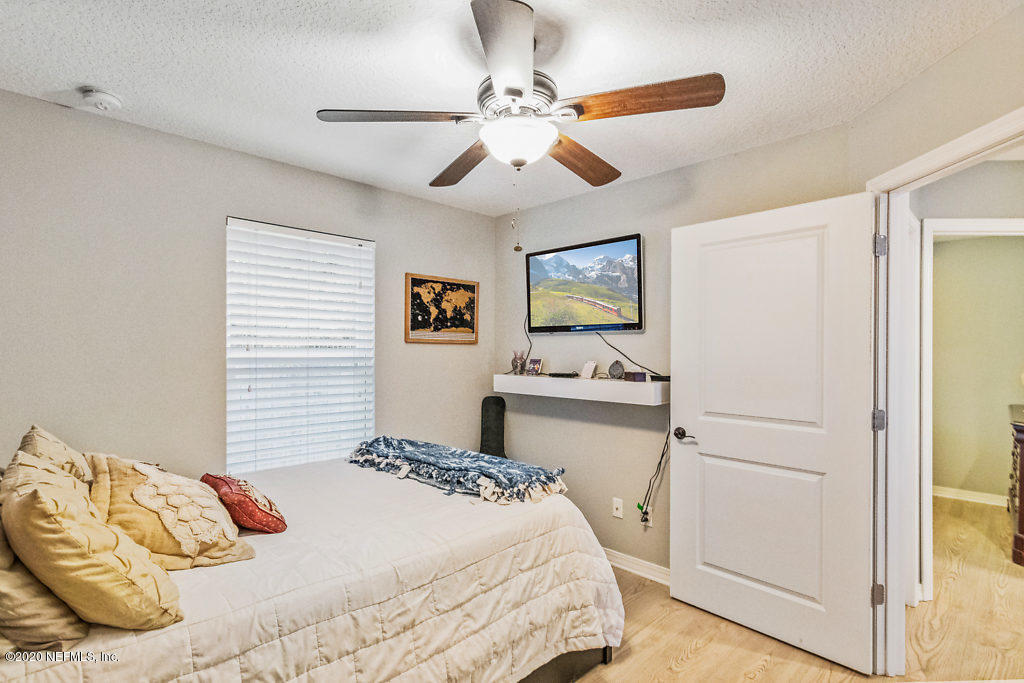 405 2nd Street St. Augustine, FL 32084 - Photo 19 of 49 a bedroom with a bed and a chandelier