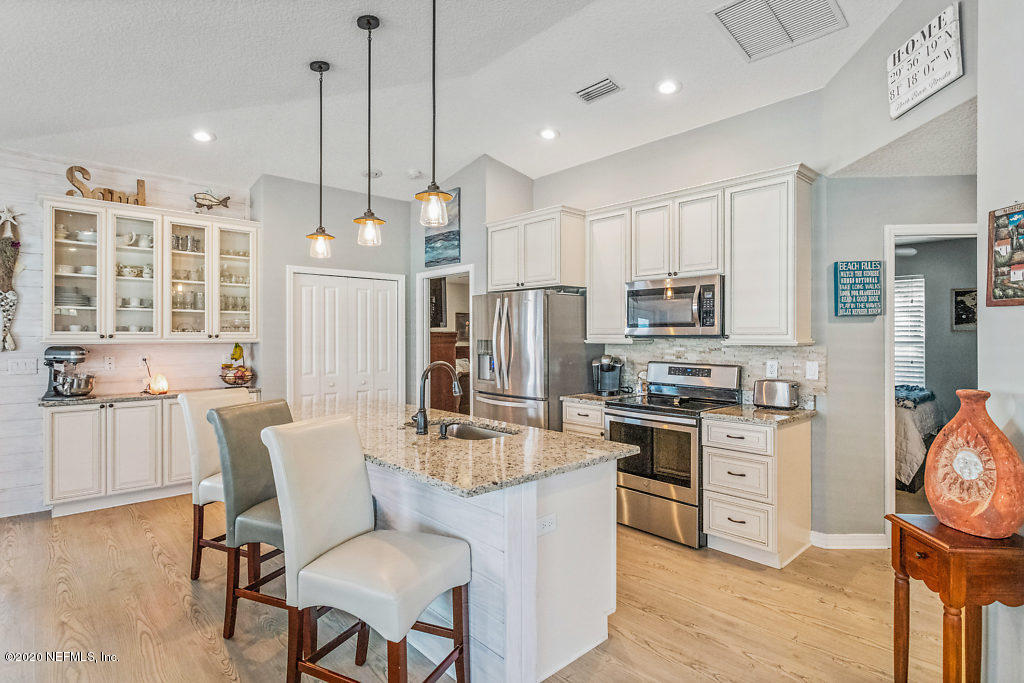 405 2nd Street St. Augustine, FL 32084 - Photo 2 of 49 a kitchen with stainless steel appliances granite countertop a stove top oven a refrigerator a sink and chairs