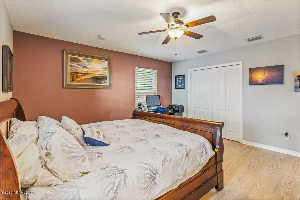 405 2nd Street St. Augustine, FL 32084 - Photo 22 of 49 a bedroom with a bed and a chandelier