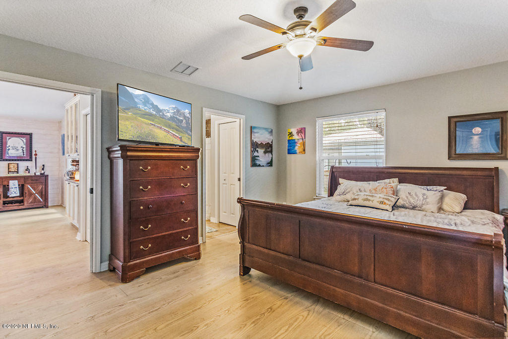 405 2nd Street St. Augustine, FL 32084 - Photo 3 of 49 a bedroom with a bed and a chandelier