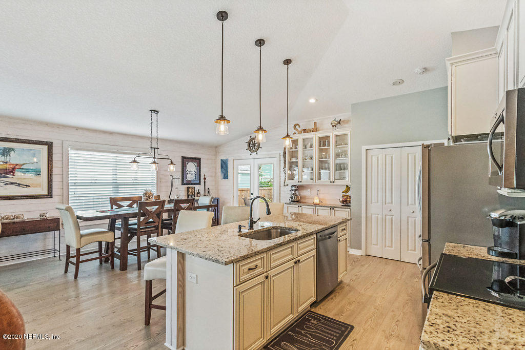 405 2nd Street St. Augustine, FL 32084 - Photo 37 of 49 a kitchen with stainless steel appliances granite countertop a sink and a refrigerator
