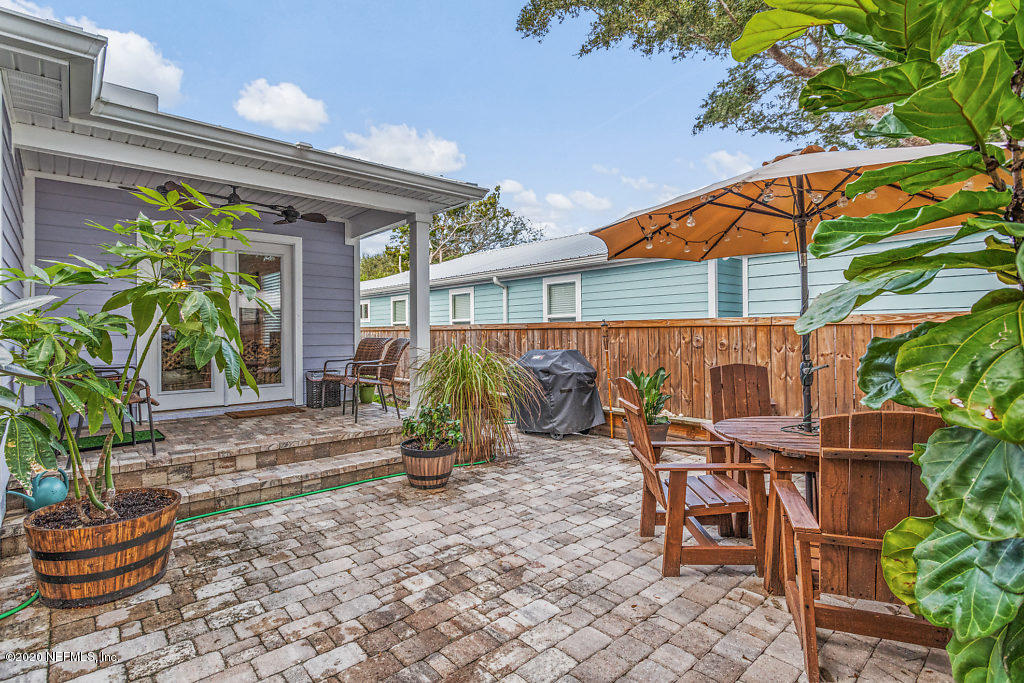405 2nd Street St. Augustine, FL 32084 - Photo 44 of 49 a view of a patio with table and chairs potted plants and floor to ceiling window