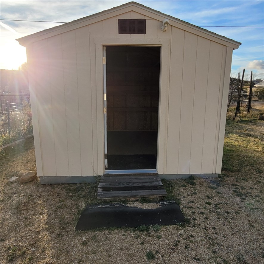 9732 2nd Street Chloride, AZ 86431 - Photo 7 of 28 The property includes a detached storage shed with light-colored siding and a gabled roof