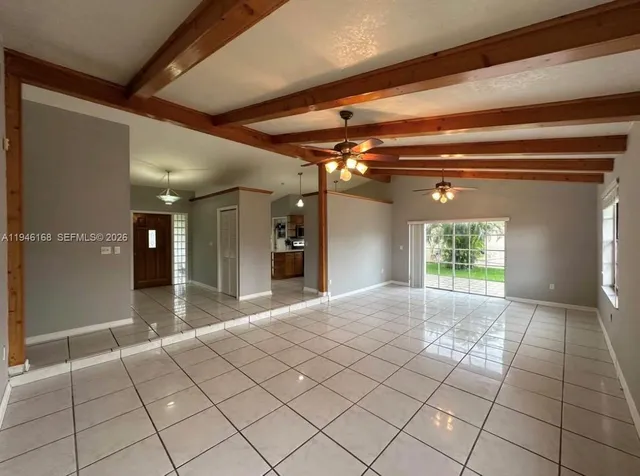 a view of hallway with stairs and a chandelier