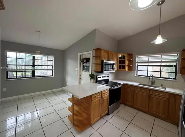 a kitchen with stainless steel appliances granite countertop a sink counter space cabinets and a window
