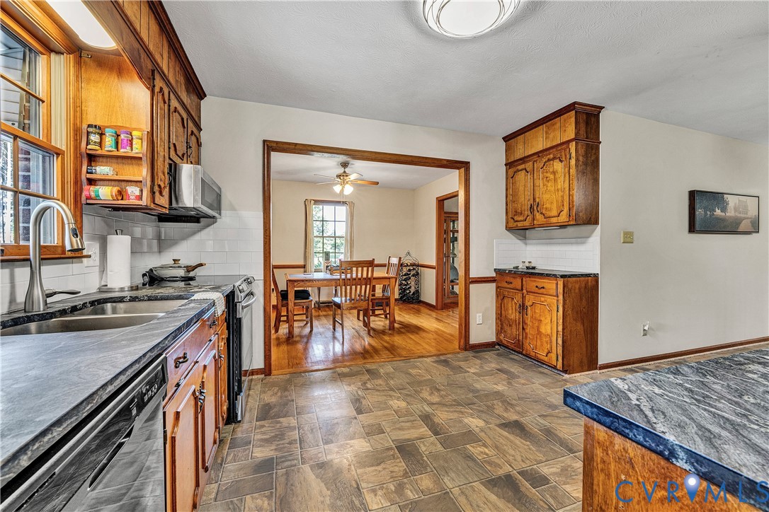 258 Willow Oak Road Appomattox, VA 24522 - Photo 11 of 50 Kitchen featuring wood cabinetry, dark stone count
