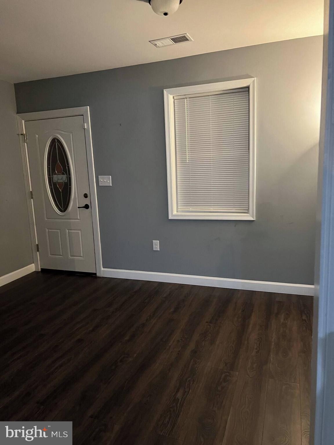 36078 Carver Road Chaptico, MD 20621 - Photo 12 of 14 an empty room with wooden floor and windows