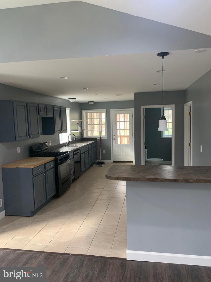 36078 Carver Road Chaptico, MD 20621 - Photo 2 of 14 a large kitchen with kitchen island a sink a counter space appliances and cabinets