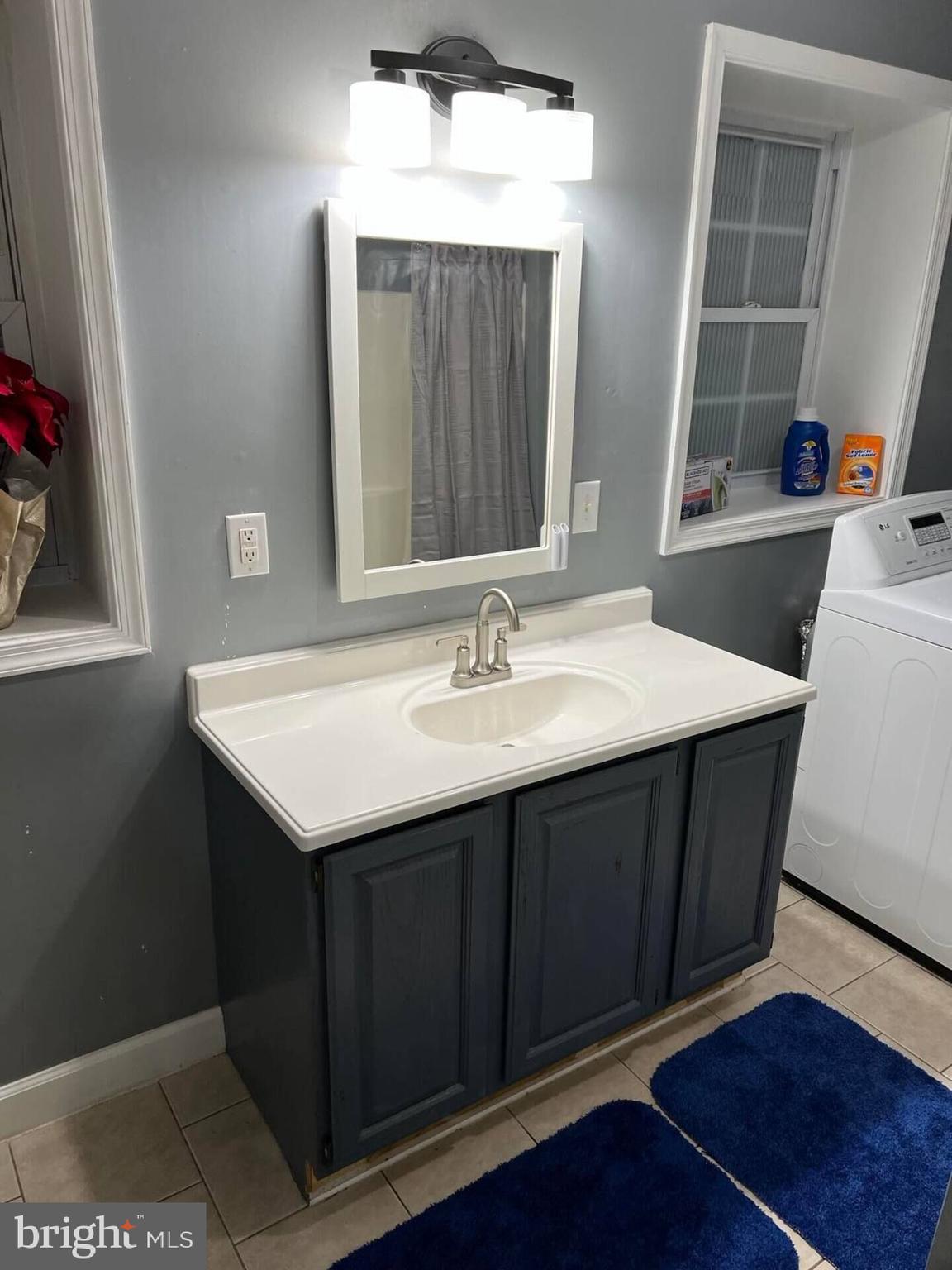36078 Carver Road Chaptico, MD 20621 - Photo 8 of 14 a bathroom with a sink vanity and a mirror