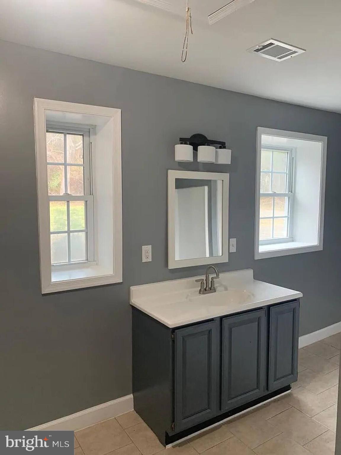 36078 Carver Road Chaptico, MD 20621 - Photo 9 of 14 a bathroom with a sink vanity and a mirror