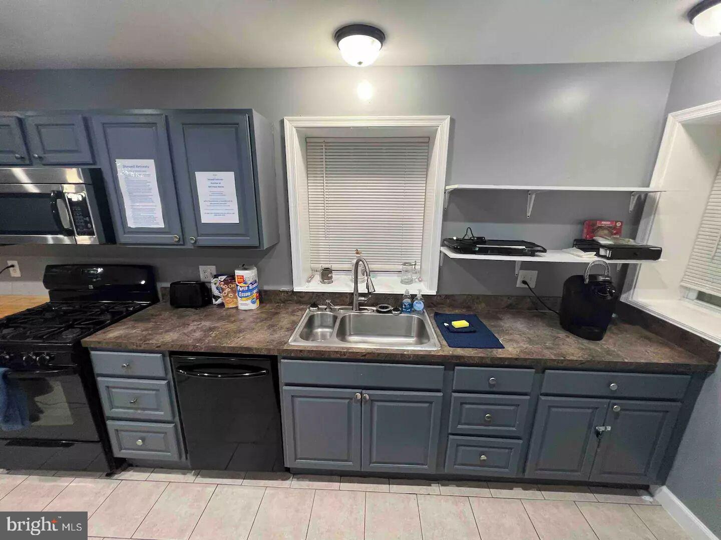 36078 Carver Road Chaptico, MD 20621 - Photo 10 of 14 a kitchen with a sink and a stove with wooden cabinets
