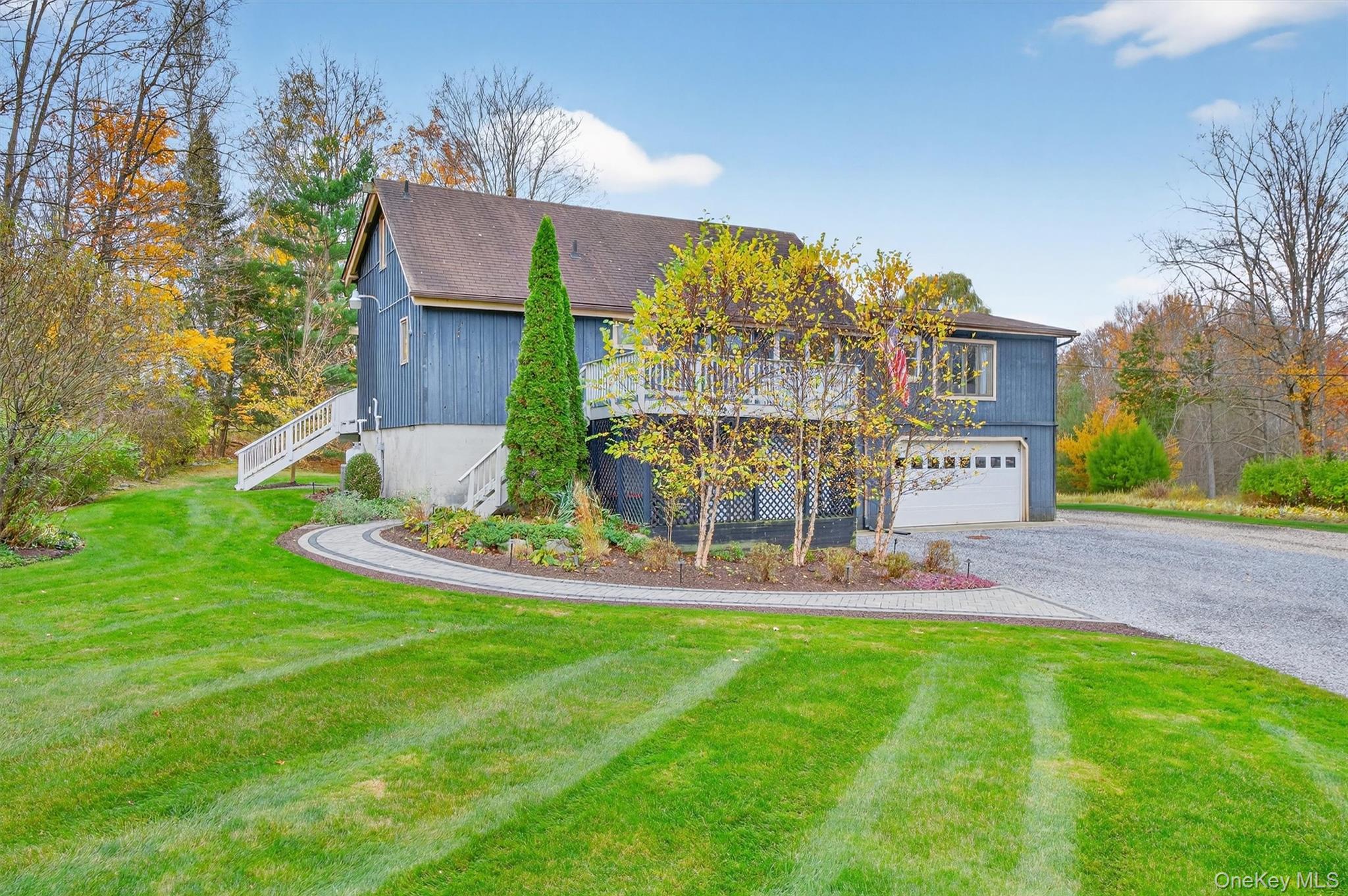 a view of a house with a yard and sitting area