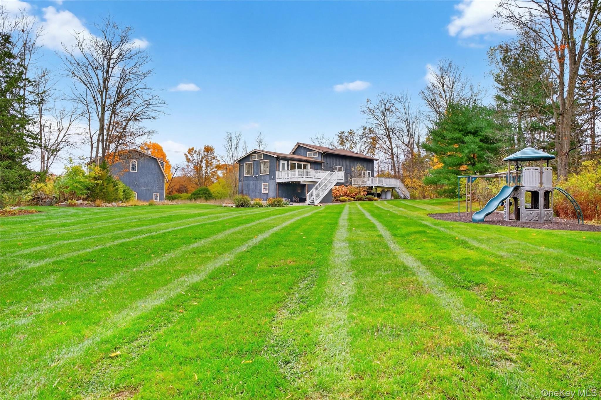 618 Salt Point Turnpike Poughkeepsie, NY 12601 - Photo 36 of 38 a view of a house with a big yard and palm trees