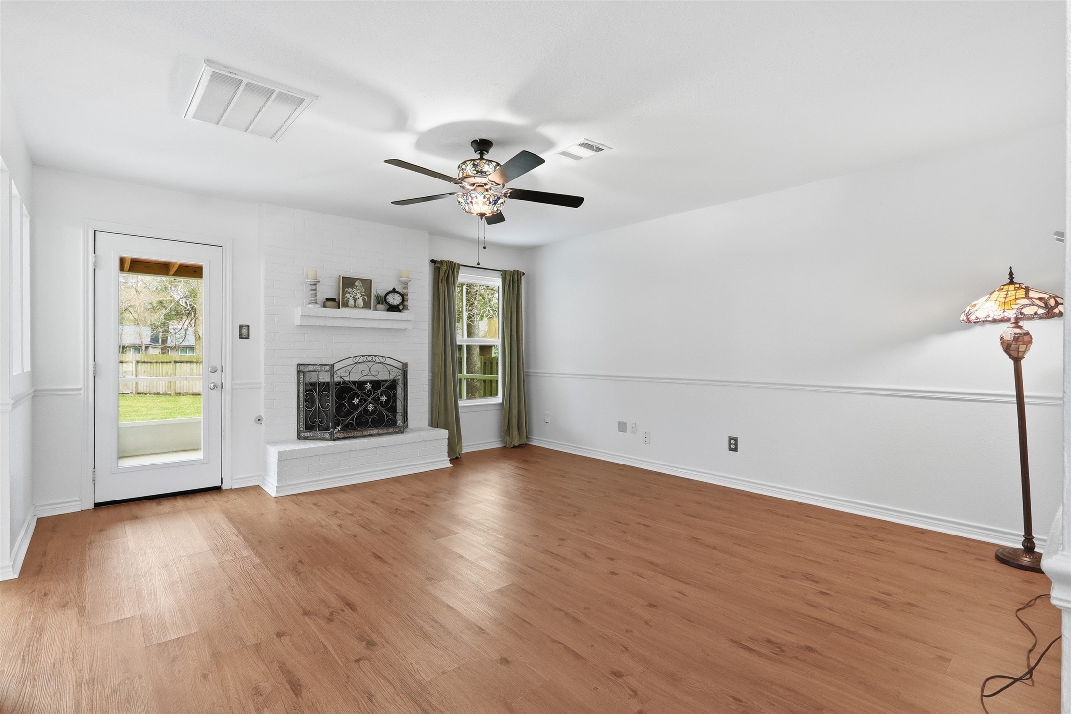 10 East Broken Oak Court Spring, TX 77381 - Photo 20 of 47 Spacious living room with brick fireplace and stained glass ceiling fan.