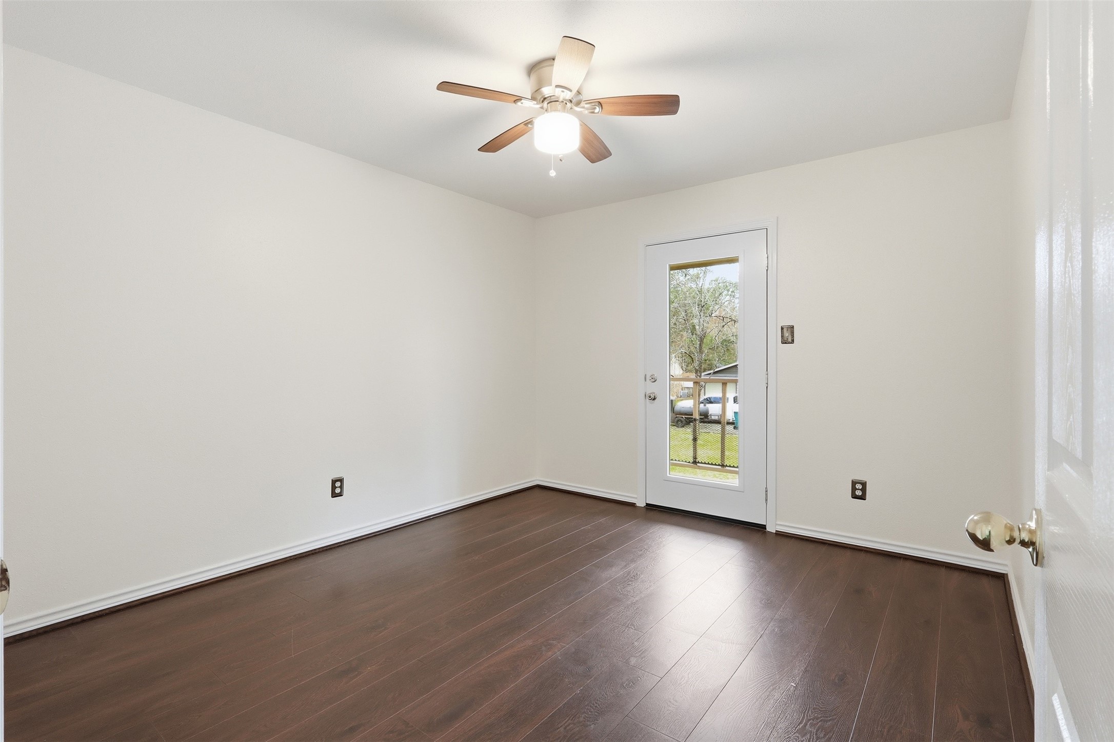 10 East Broken Oak Court Spring, TX 77381 - Photo 33 of 47 Secondary bedroom with connected balcony access and view of the charming neighborhood street.