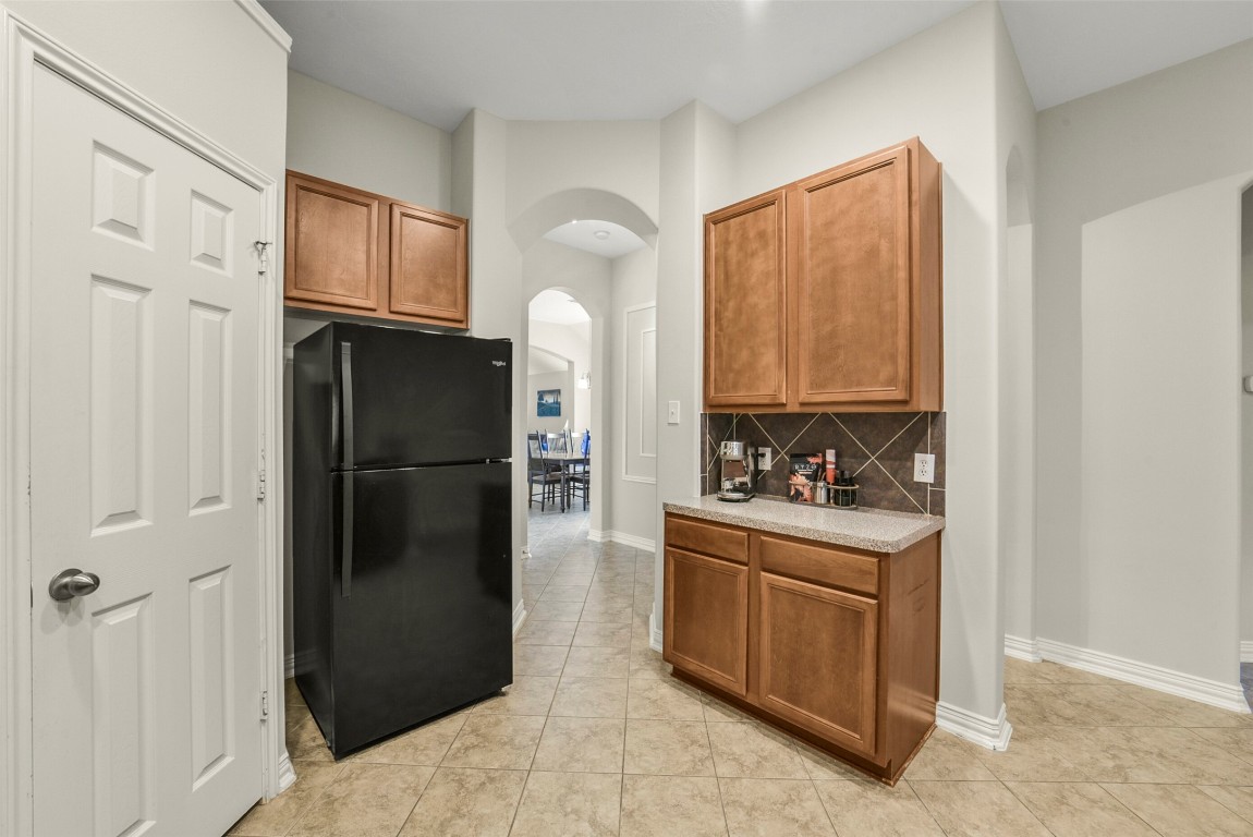 25103 Diamond Ranch Drive Katy, TX 77494 - Photo 16 of 34 The door to the left of the refrigerator opens to the pantry.