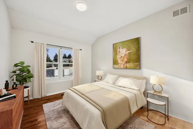 a bedroom with a bed and a potted plant