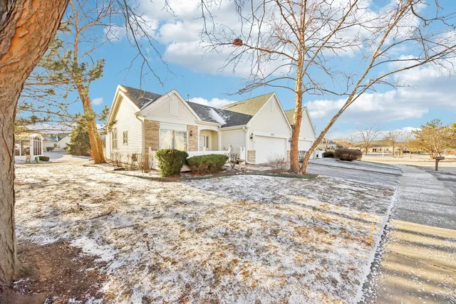 a view of a large house with a yard and large tree