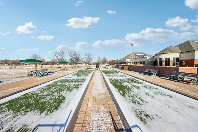 a view of swimming pool with outdoor seating and city view