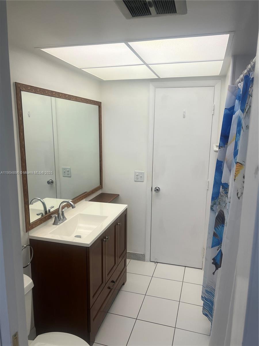 2501 West Golf Boulevard, Unit 128 Pompano Beach, FL 33064 - Photo 14 of 51 a bathroom with a sink and a mirror