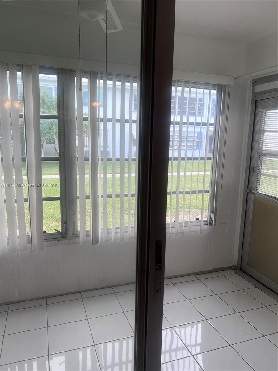 2501 West Golf Boulevard, Unit 128 Pompano Beach, FL 33064 - Photo 17 of 51 a view of an empty room and window