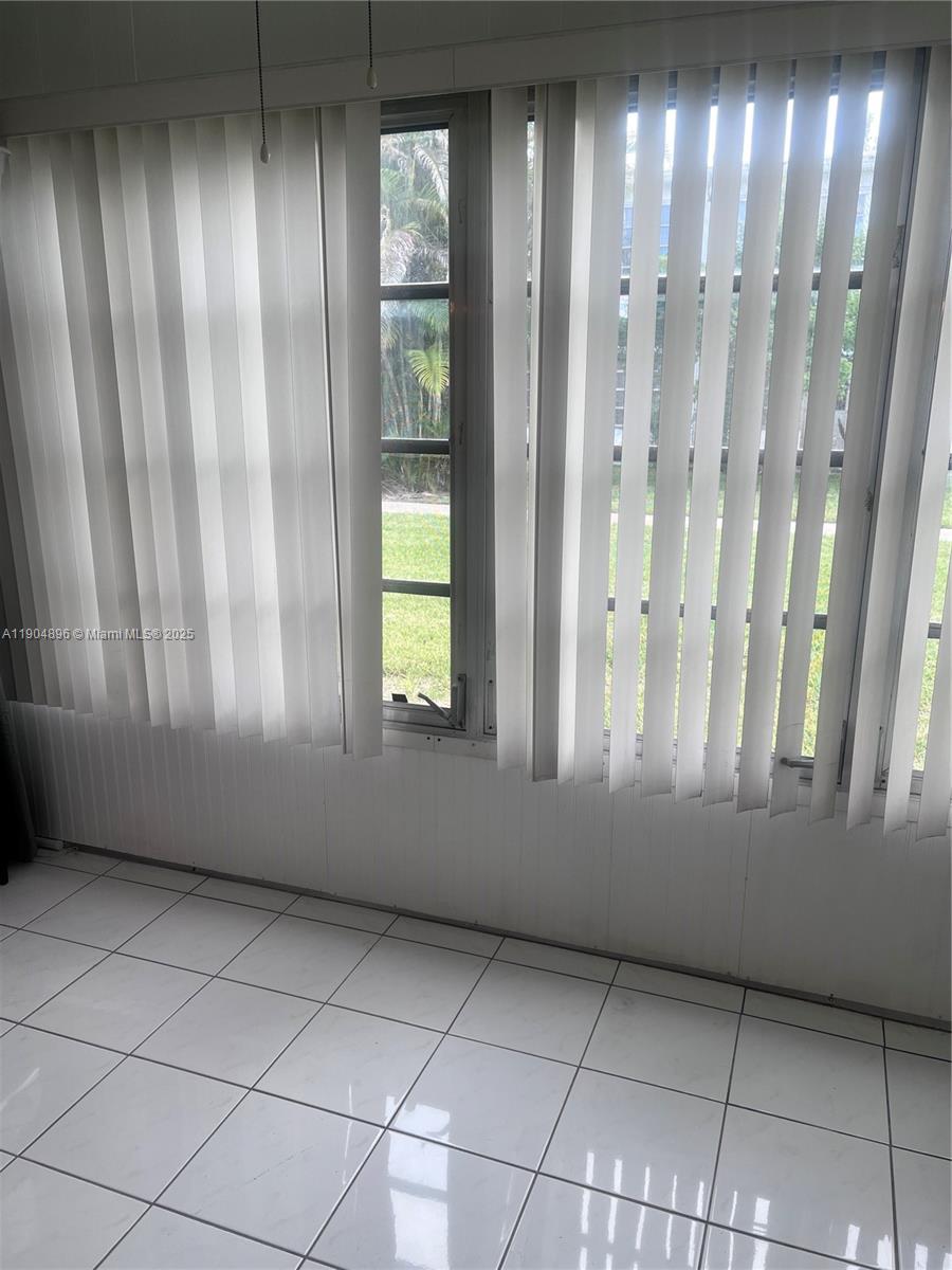2501 West Golf Boulevard, Unit 128 Pompano Beach, FL 33064 - Photo 18 of 51 a view of an empty room with a window