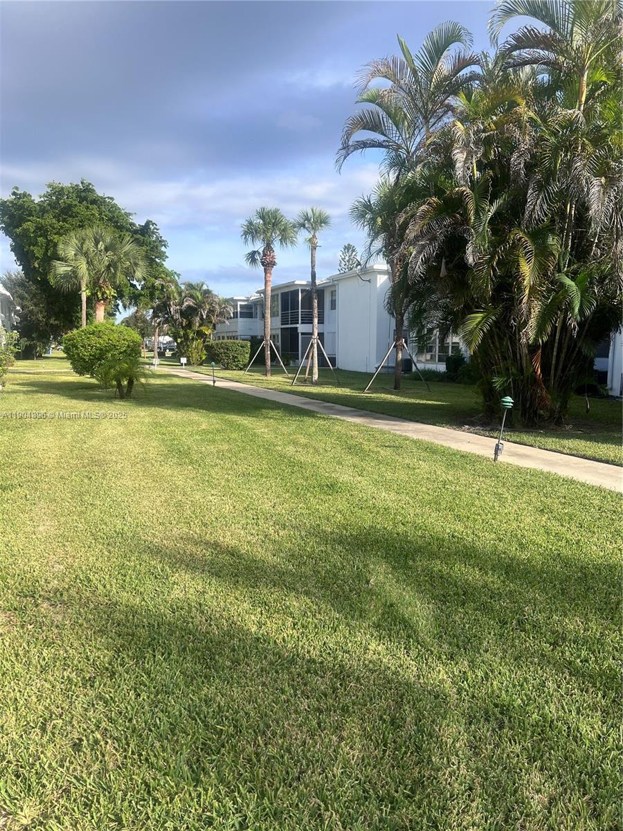 2501 West Golf Boulevard, Unit 128 Pompano Beach, FL 33064 - Photo 19 of 51 a backyard of a house with lots of green space and lake view