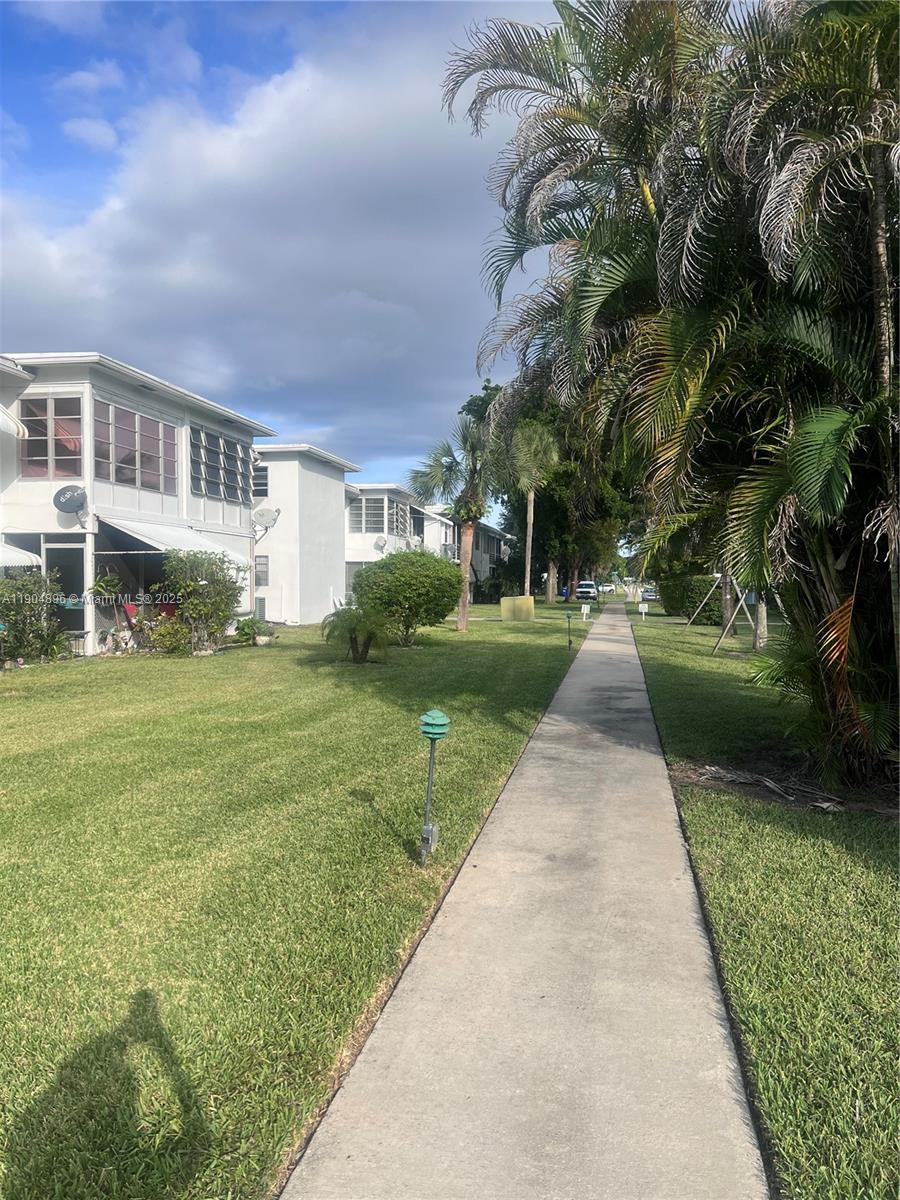 2501 West Golf Boulevard, Unit 128 Pompano Beach, FL 33064 - Photo 20 of 51 a view of a house with a yard