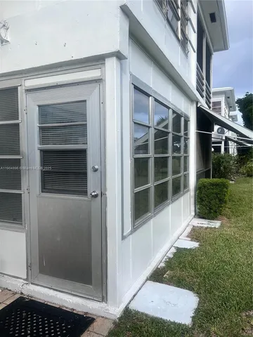 a view of front door and yard