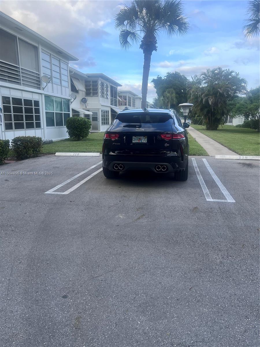 2501 West Golf Boulevard, Unit 128 Pompano Beach, FL 33064 - Photo 27 of 51 a car parked in front of a house