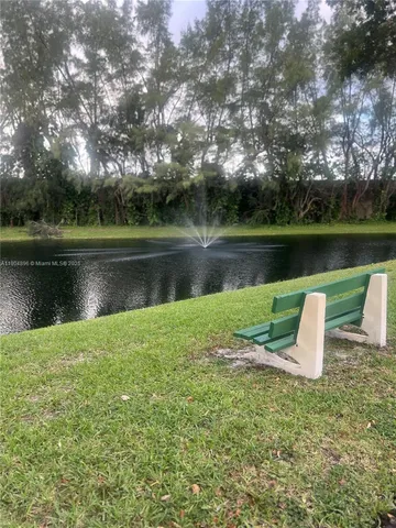 a large body of water next to a lake with a building in the background