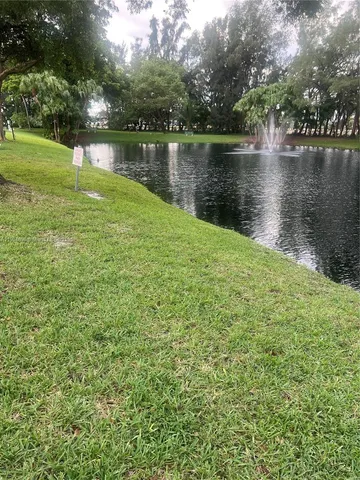 a view of a lake with a garden and plants