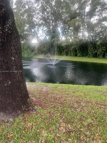 a large body of water next to a lake with a building in the background