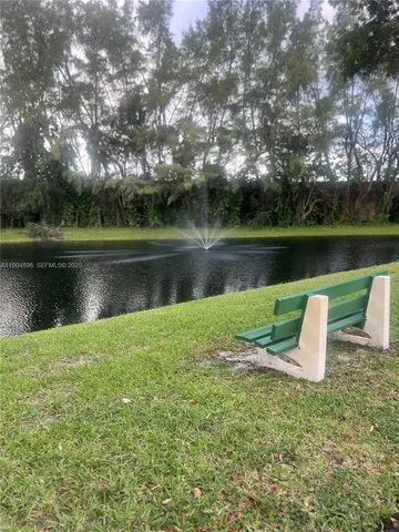 a view of a lake with a garden and plants