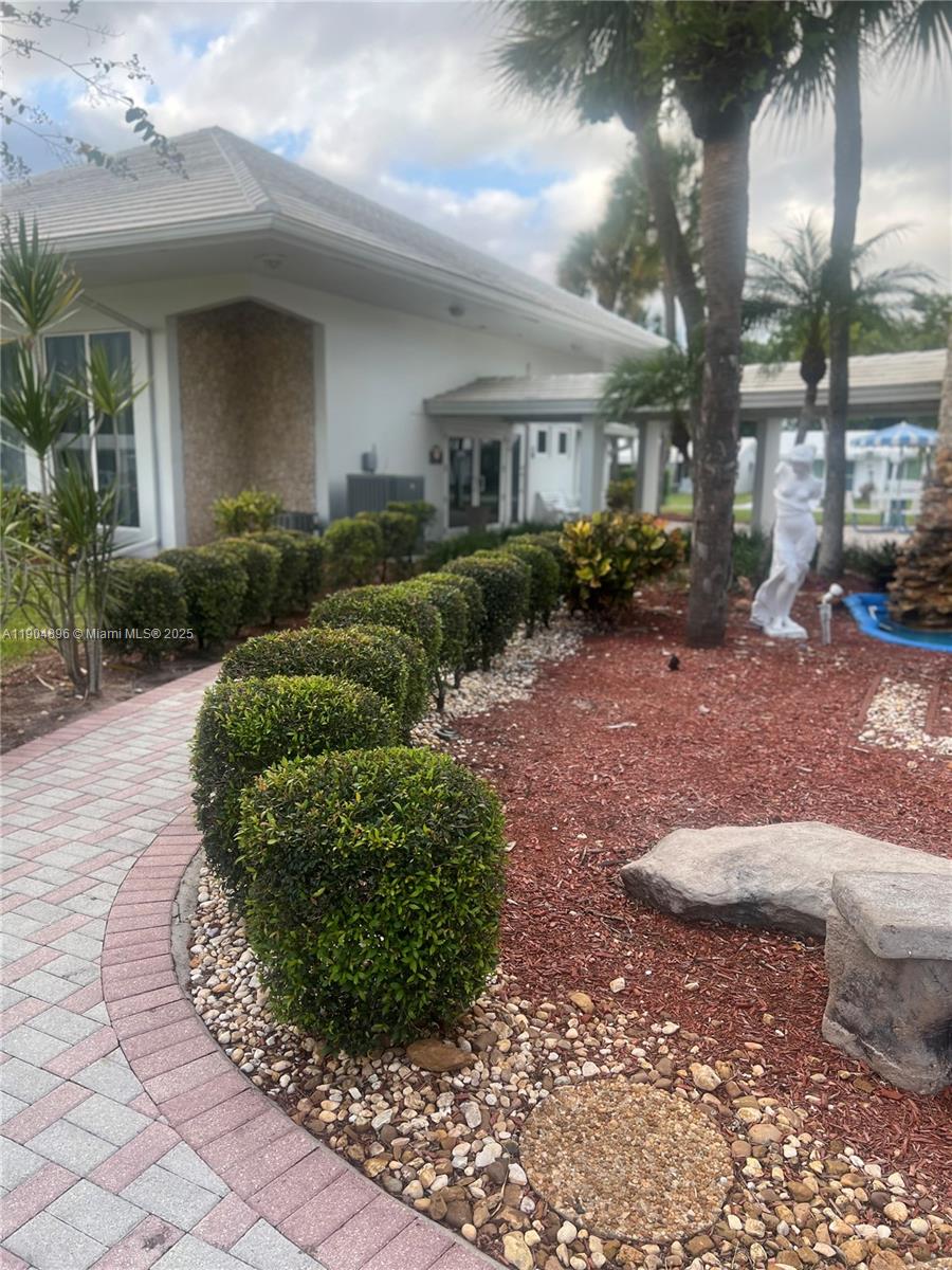 2501 West Golf Boulevard, Unit 128 Pompano Beach, FL 33064 - Photo 35 of 51 a view of a house with a yard and plants