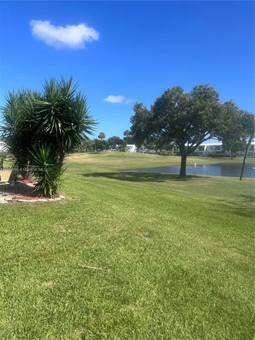 a view of a chairs and table in patio
