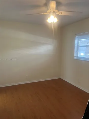 an empty room with a empty space and windows
