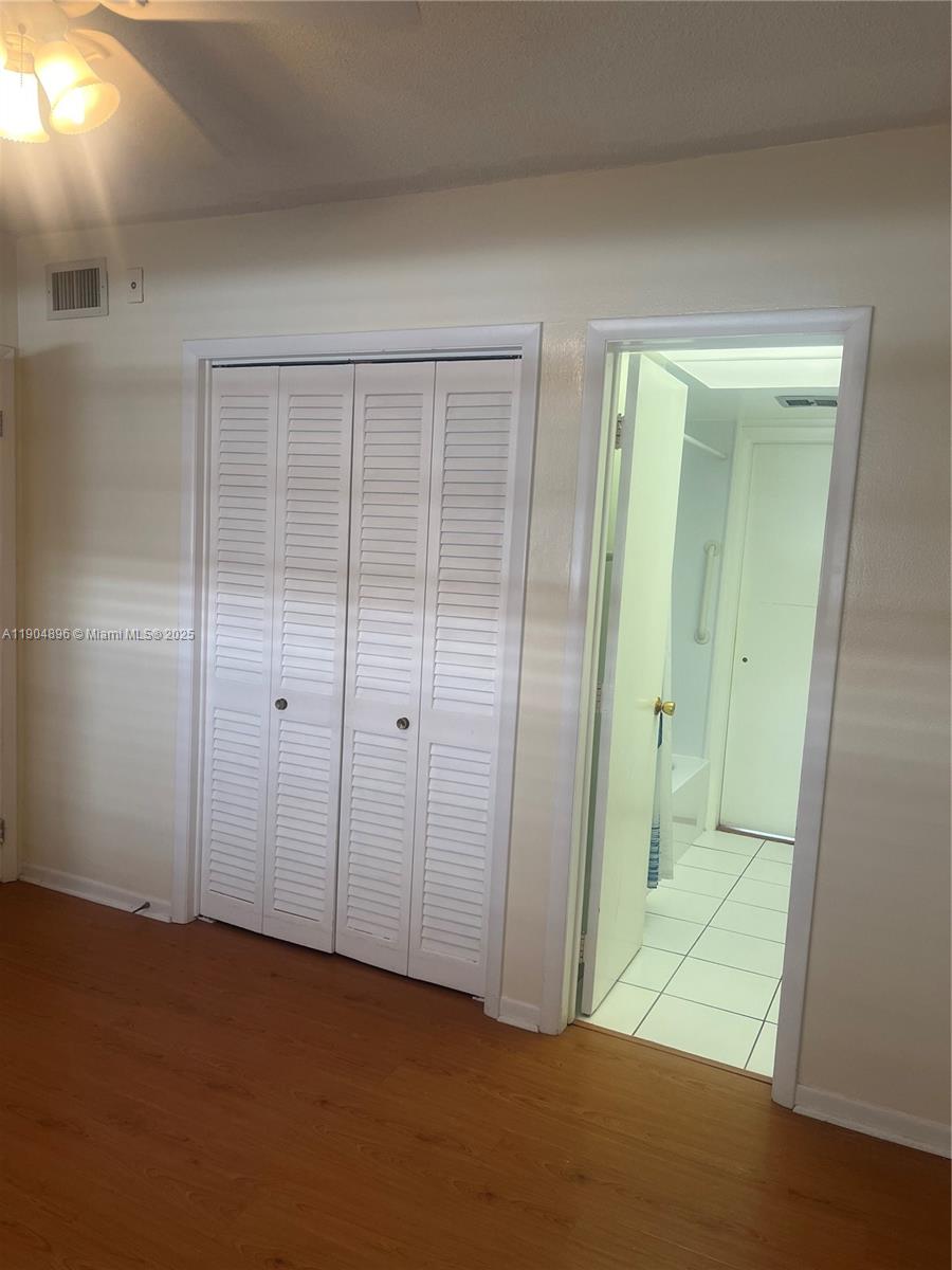 2501 West Golf Boulevard, Unit 128 Pompano Beach, FL 33064 - Photo 9 of 51 an empty room with an entryway door
