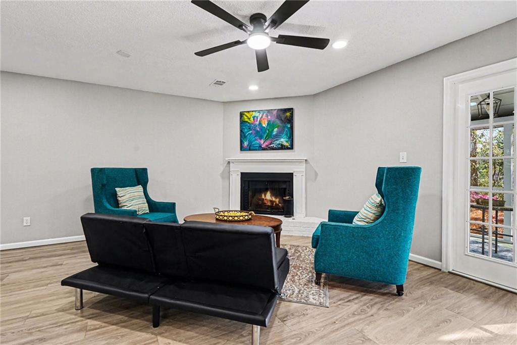 6052 WinterGreen Road Northwest Norcross, GA 30093 - Photo 5 of 24 a living room with furniture and a fireplace