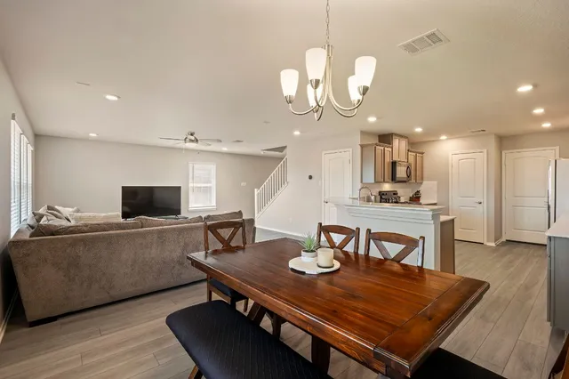 a living room with dining table and chairs