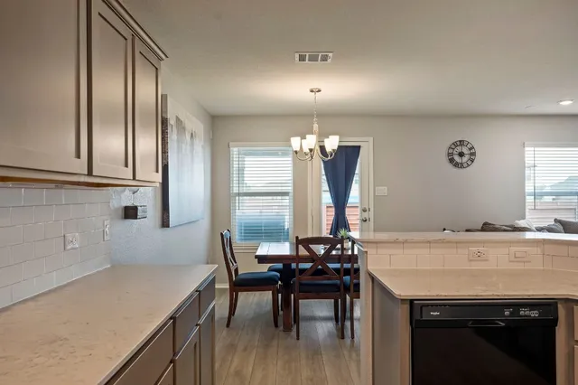 a kitchen with granite countertop a sink appliances and cabinets